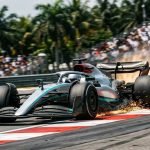 F1 Sepang 2026 preview high speed racing car carving through apex curbs with sparks flying under tropical sunlight